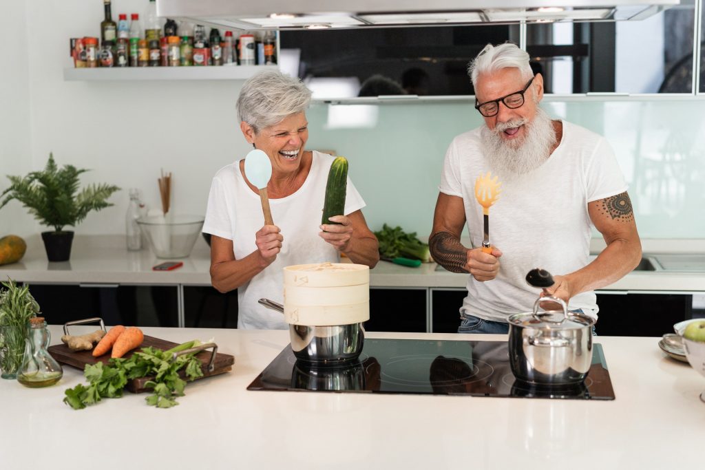 happy-senior-couple-having-fun-dancing-and-cooking-2023-11-27-04-55-17-utc-min